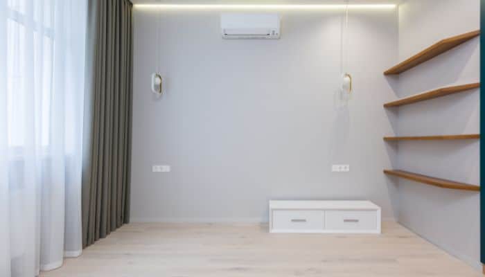 Living room furniture moved aside to allow AC unit installation access