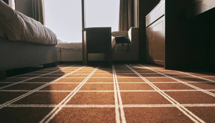 Why Hydronic Radiant Floor Heating Costs So Much Modern room showcasing benefits of hydronic radiant floor heating system